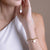 Woman wearing Solar Link Bracelet in Gold