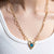 woman wearing a Moon phase Atlas Heart Necklace in Gold