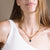 Woman wearing gold plated curb chain necklace with constellation astrology pendant 